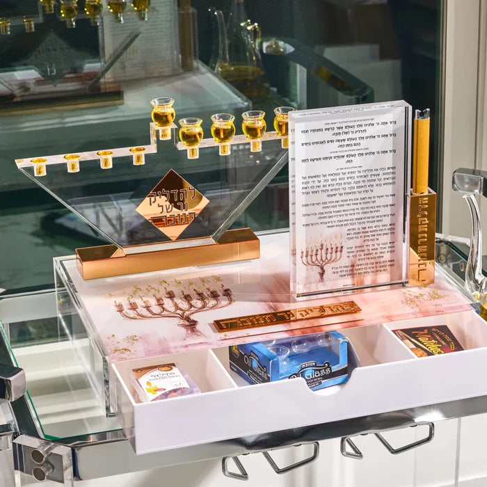 Clear Lucite menorah with gold cups on the painted menorah tray for Chanukah, drawer open showing candles and lighting essentials