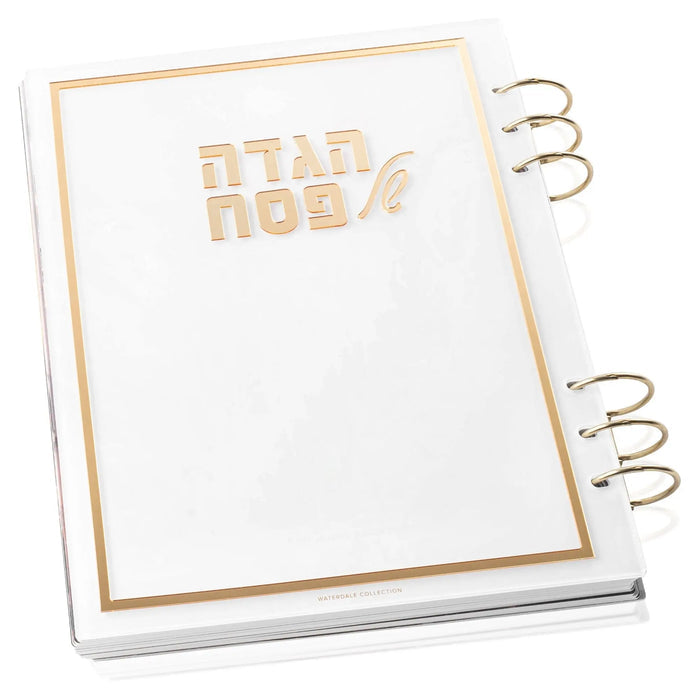Painted by Batya lucite Haggadah with gold foil text and metallic binding rings on white cover, Pesach holiday book.