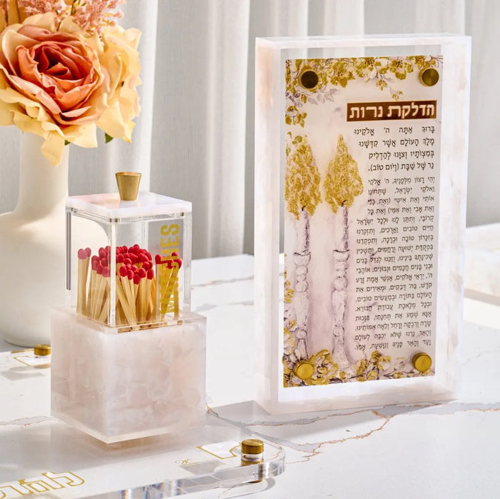 Painted Frame Hadlokas Neiros in pearl marble with gold accents, displayed on white surface with flowers and candles nearby