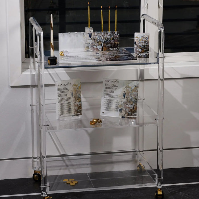 Painted Jerusalem Menorah Chanukah matchbox holder styled on a glass shelf beside a menorah for Chanukah