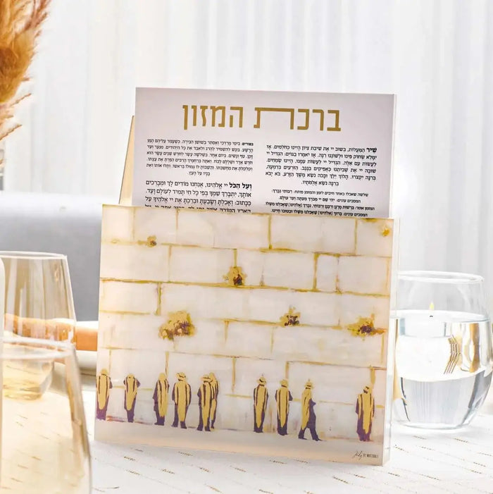 Painted Kosel Bencher Set with cream boxes stacked on wooden stand, featuring gold wire card holders and Hebrew text card on top, displayed with glasses and dried flowers.
