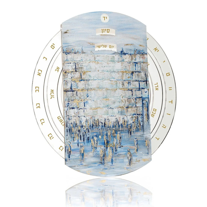 Painted Kosel Calendar Wheel tabletop plaque featuring blue and white watercolor design of the Western Wall with Hebrew month markers around oval border.