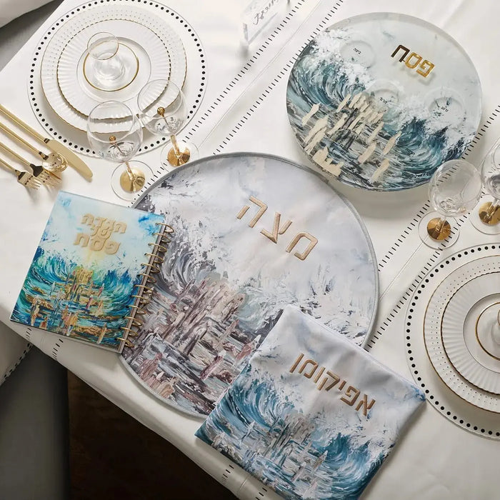 Waterdale Collection painted pillow case featuring blue watercolor architectural designs on cream linen, displayed with coordinating tableware.