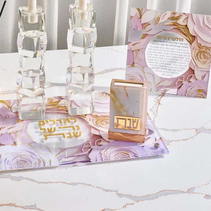 Waterdale Collection papercut Hadlakas Neiros tabletop display with gold-foil Jewish prayer art on marble surface, styled with candles and flowers.