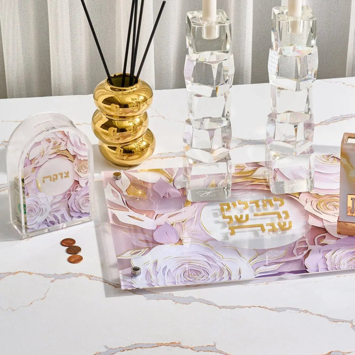 Waterdale Collection donut reed diffuser with golden yellow glaze displayed among clear glass bottles and purple floral accessories on white surface.