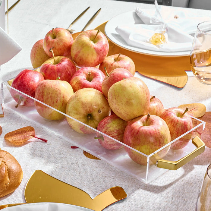 Pearlstone marble bread tray filled with fresh apples, displayed on a white table with autumn decor and serving pieces nearby.