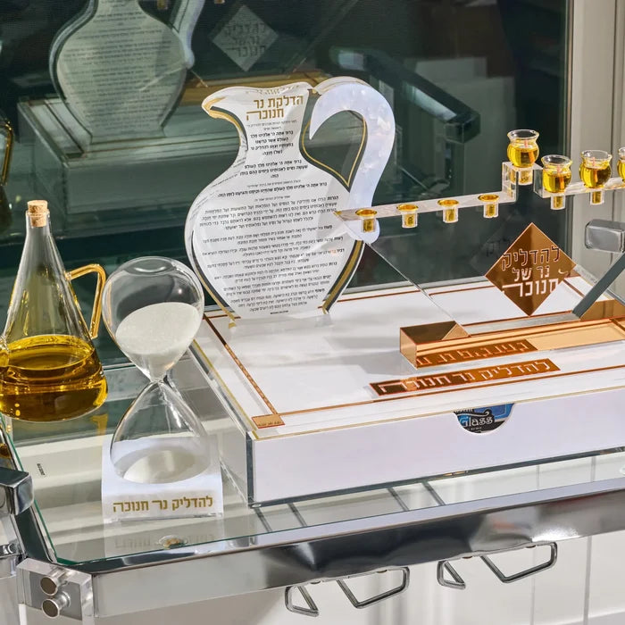 The Pearlstone Oil Jug Chanukah Block in gold, its Hadlakas Ner Chanukah lettering printed across the marbled face for Hanukkah