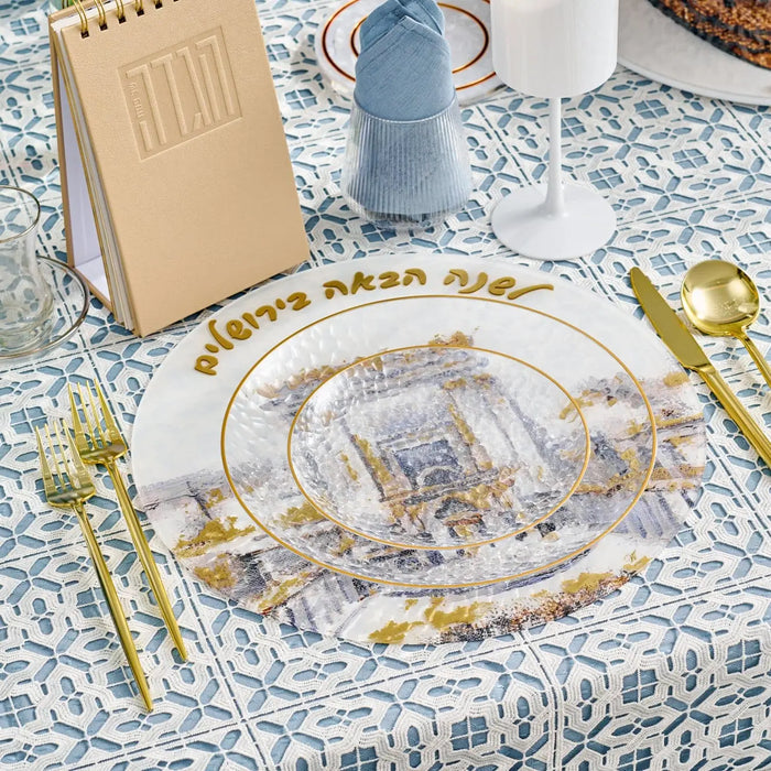 Pesach Bais Hamikdash charger plate with gold Jerusalem temple design on white, displayed with place setting and tableware