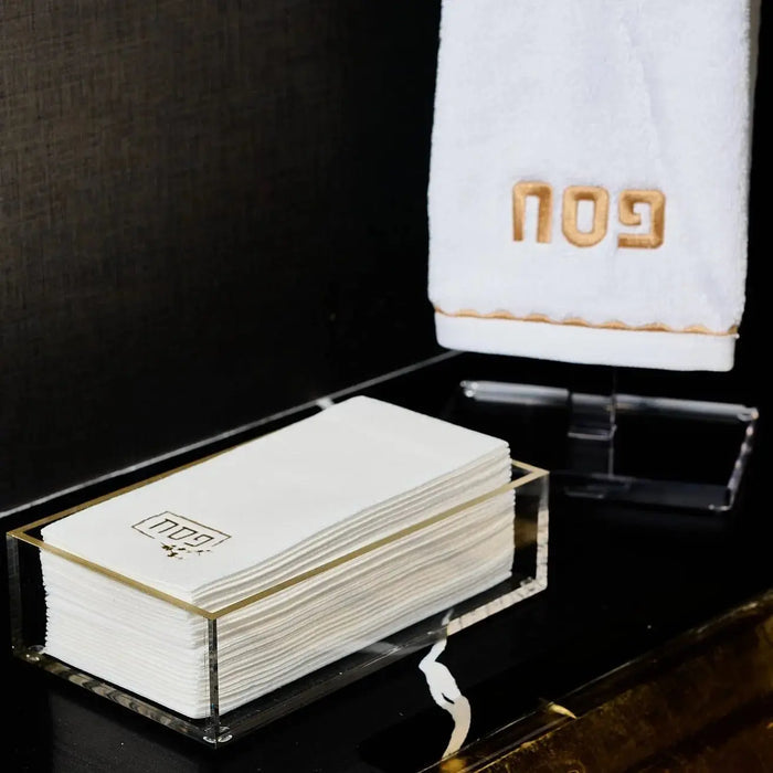 Waterdale Collection Pesach guest towelettes in cream and gold, displayed on dark surface with elegant packaging for holiday table settings.