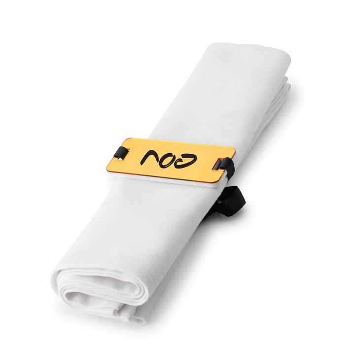 Gold Pesach napkin wrap holding a rolled white napkin, part of Waterdale Collection's holiday tabletop dinnerware set.