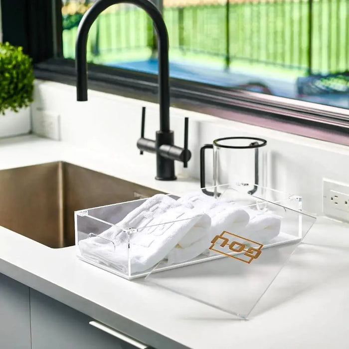 Waterdale Pesach towel box with white towels displayed on kitchen counter next to black faucet and sink
