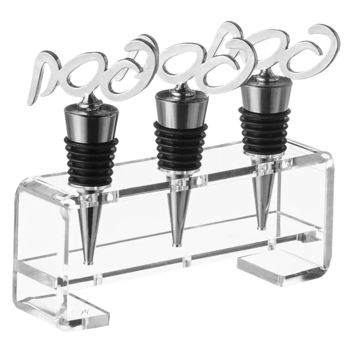 Three black wine stoppers with decorative silver handles displayed in a clear acrylic stand, perfect for Pesach wine service and tabletop entertaining.