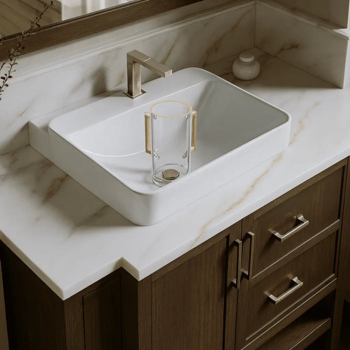 Pop-Drain Washing Cup in white ceramic displayed on a bathroom vanity sink countertop with chrome faucet