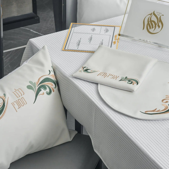 Prestige Pesach Set in white and gold leather by Waterdale Collection, featuring elegant tabletop items arranged on a white surface with gold accents.
