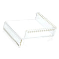 Waterdale Collection raised inspired napkin holder in clear acrylic with decorative beaded trim detail, displayed at an angle showing the open rectangular design.