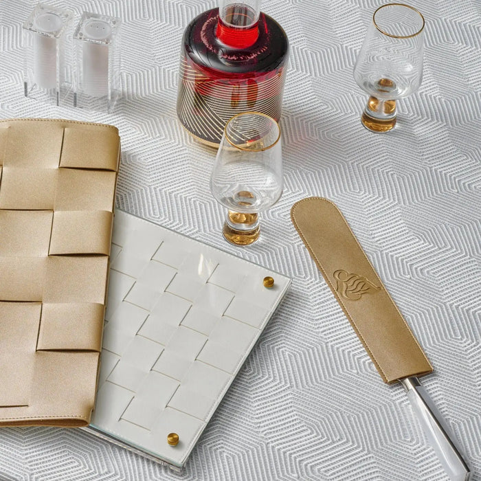 Tan leather knife blade cover displayed on a challah board with Shabbat items and wooden handled knife, showcasing the Regal collection's protective kitchen accessory.