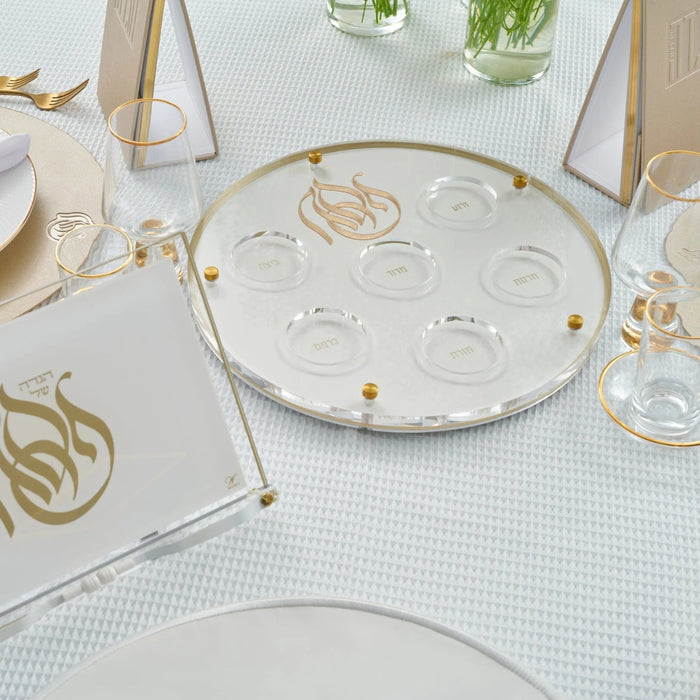 Regal Seder Plate with gold-trimmed rim and embossed sections for Pesach foods, displayed on white table with place settings and glassware.