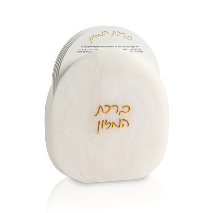 Cream resin bencher set with gold Hebrew text, perfect for Shabbat and holiday table settings from Waterdale Collection.