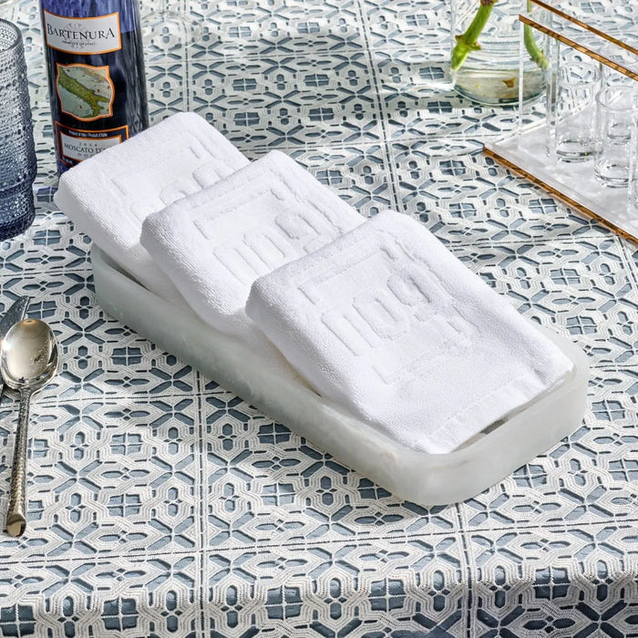 White resin Pesach towel tray set displayed on decorative tile surface with bathroom accessories nearby
