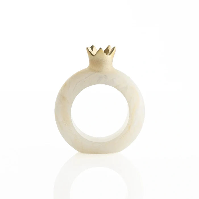 Gold resin pomegranate napkin rings styled on a holiday table setting