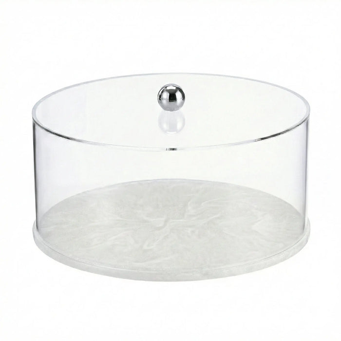 Round clear resin cake dome with white marble base and chrome knob, ideal for serving and displaying desserts at gatherings.