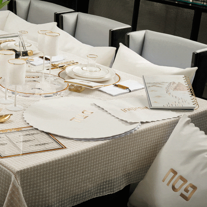 Waterdale Collection scalloped edge Pesach leather set displayed on table with white napkins and gold cutlery for holiday dining.