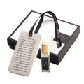 Scented Stone Tefillas Haderech Diffuser with black cord and wooden accent piece displayed on gray tray with packaging.