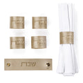 Gold leather Shabbos napkin wraps with matching white cloth napkins, displayed as a complete hostess set for Shabbat table settings.