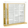 Gold and silver side opening bencher set with Zemiros text visible on open pages, displayed on tabletop for Shabbat use.