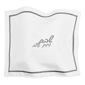 White leather challah cover with silver trim and embroidered Hebrew text, hotel-style design for Shabbat dining.
