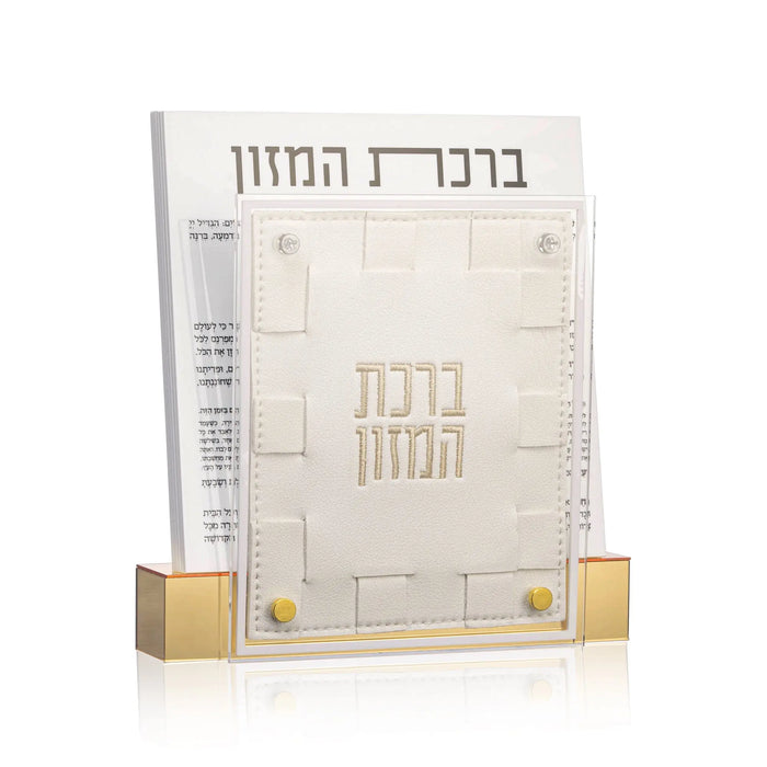 Small woven bencher set with gold accents and Hebrew text, displayed in packaging with matching decorative holder for Shabbat and holiday tables.