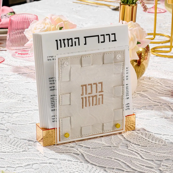 Cream woven bencher set with gold accents displayed on white surface with pink and gold decor nearby.