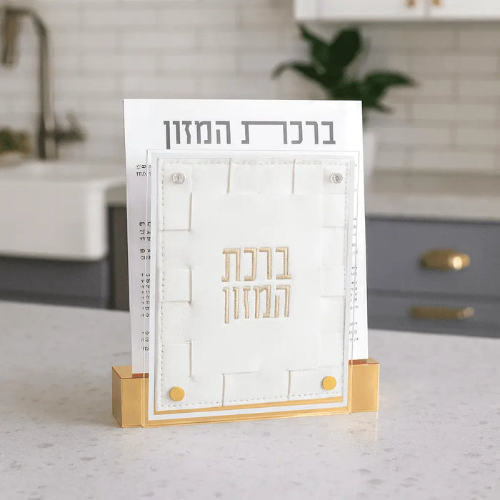 Small woven bencher set with white cover and gold accents displayed on kitchen counter