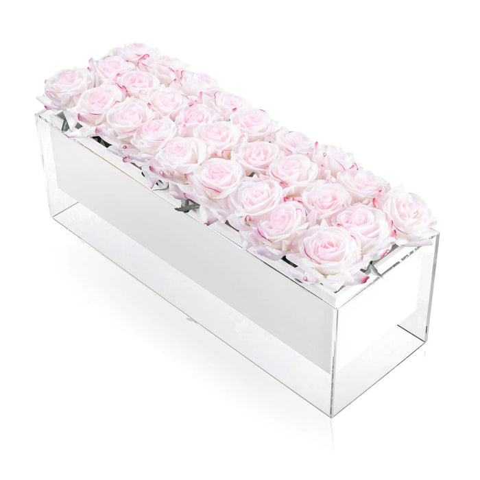 Soft pink faux roses arranged in a clear rectangular acrylic box, elegant tabletop floral centerpiece by Waterdale Collection.