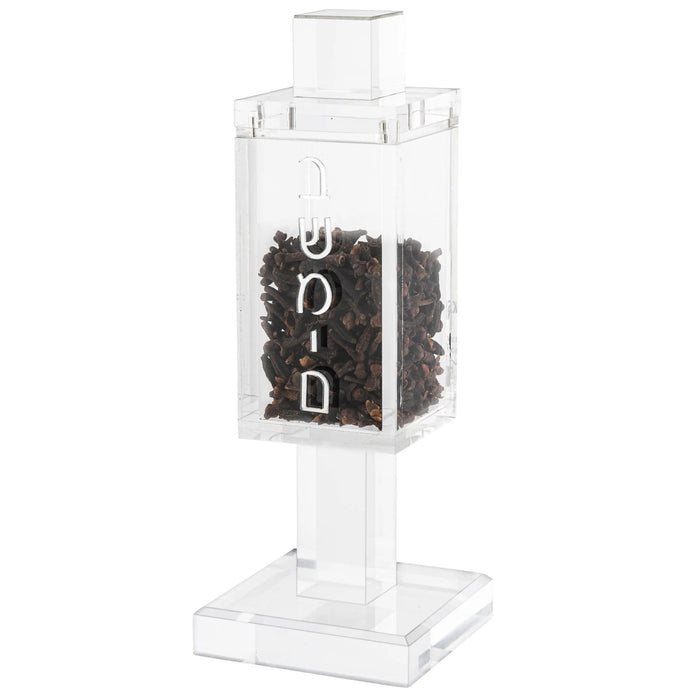 Square clear acrylic besamim holder with dark clove contents and white lettering on pedestal stand for Shabbat and Jewish holidays