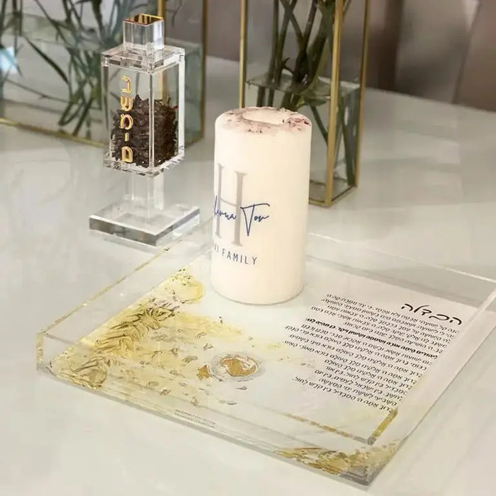 Square besamim holder in clear glass with metal accents, displayed on white marble surface with spice jar nearby, perfect for Shabbat.