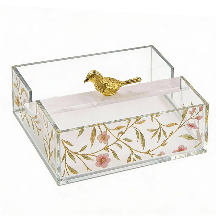 Square floral bird napkin holder with gold leaf design, clear acrylic sides, and decorative gold bird finial on white napkin base.