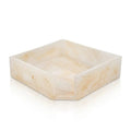 Square cream-colored resin napkin holder with natural stone-like texture, perfect for Pesach tabletop entertaining