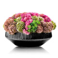 Black succulent flower pot with vibrant pink, green, and neutral faux flowers arranged in a dome shape, perfect for tabletop decor.
