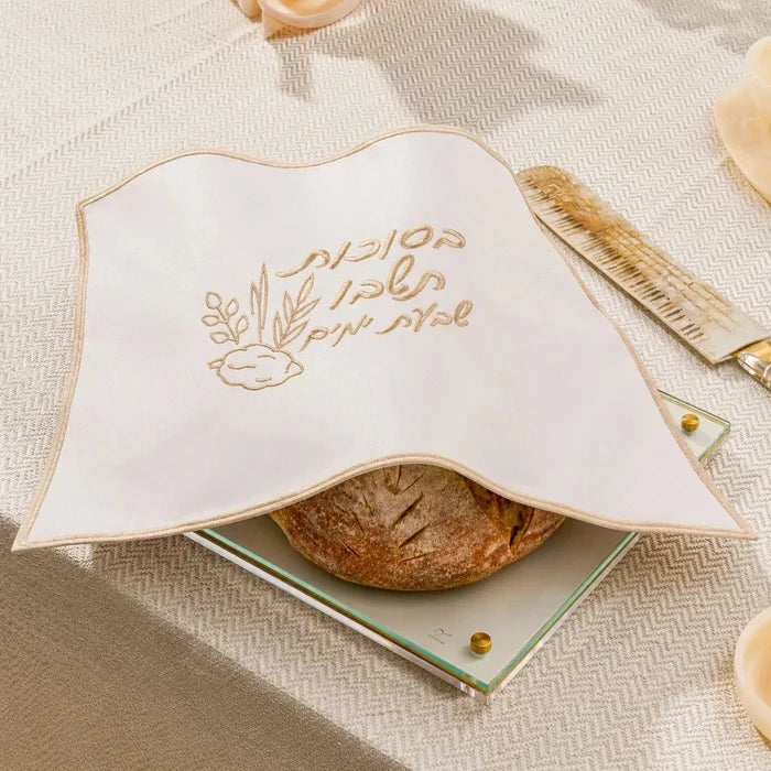 Sukkos challah cover laid over the challah on a set Yom Tov table, for Sukkot (סוכות)
