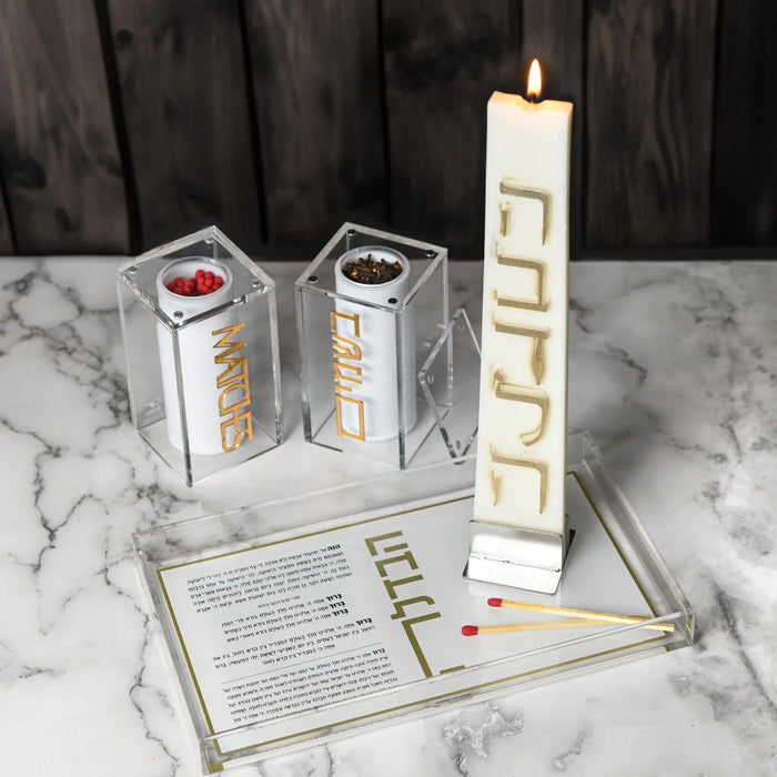 Suspended Besamim Jar match holder by Waterdale Collection in silver with white candles and instruction card displayed on marble surface.