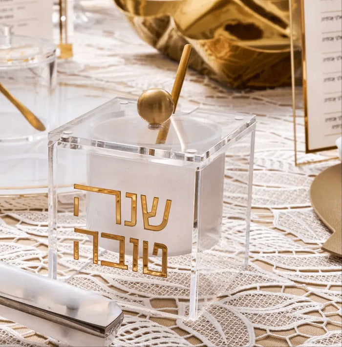 Gold suspended honey dish for a Rosh Hashana table