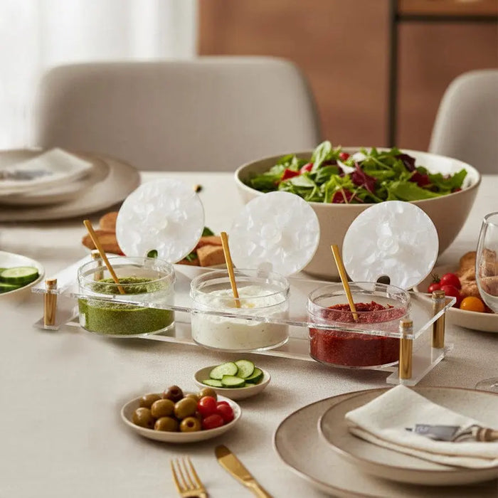 Suspended Pearlstone Dip Bowl Set in white marble displayed on a dining table with appetizers and place settings for entertaining.