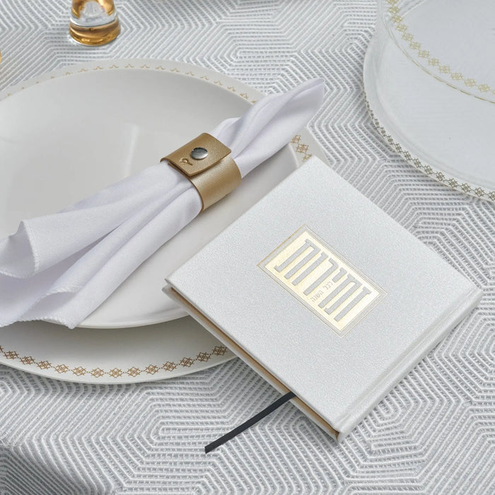 White and gold Shabbos bencher set with napkin rings on formal place setting, Waterdale Collection Zemiros Bencher for holiday entertaining