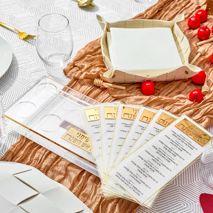 Suspended simanim tray card set on a woven placemat for a Rosh Hashonah table