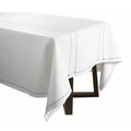 White leather tablecloth with hemstitch border detail, displayed on table with black chair legs visible underneath.