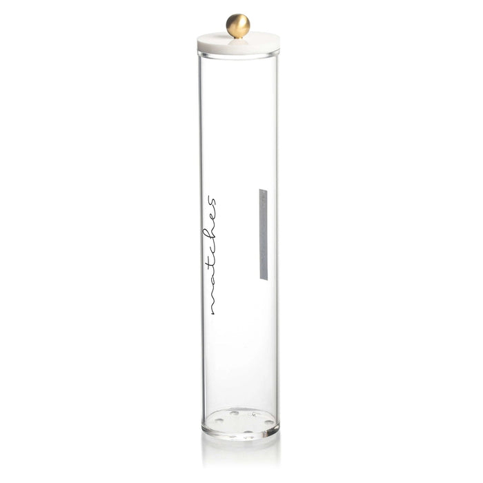 Tall clear glass cylinder match holder by Waterdale Collection with white ceramic lid and gold finial, featuring gray striker pad.