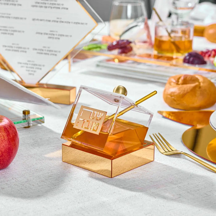 Tilt acrylic honey dish filled with honey, styled with an apple for Rosh Hashonah