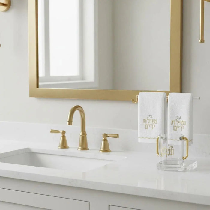 Clear acrylic towel and cup stand with ring holder displayed on bathroom vanity counter next to mirror and sink