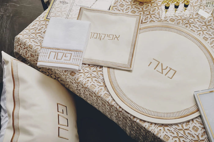 Waterdale Collection Trinket Pesach Set with white and gold leather components displayed on lace table setting, including round plate and matching accessories.